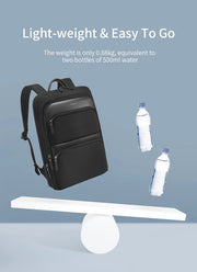 Black backpack on a balance scale with two bottles of water, indicating its lightweight nature.