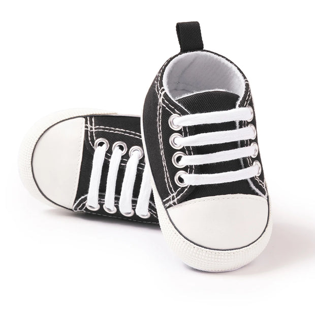 Black and white baby sneakers on a white background