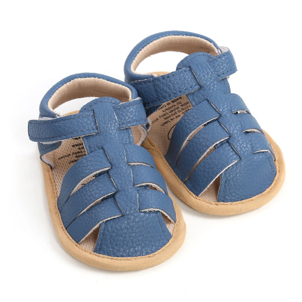 Pair of blue baby sandals on a white background