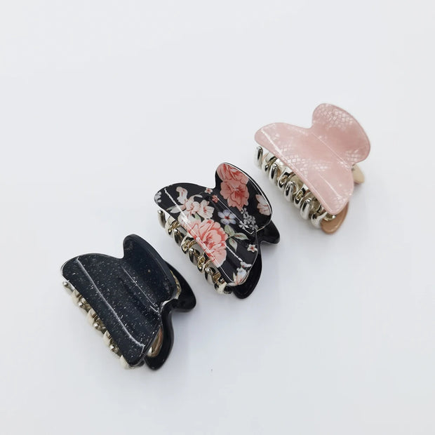 Three hair clips with floral design on a white background