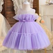 Lavender tulle dress on a mannequin with a blurred decorative background
