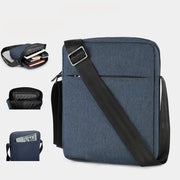 Blue tablet bag with black strap and accessories on a white background, 