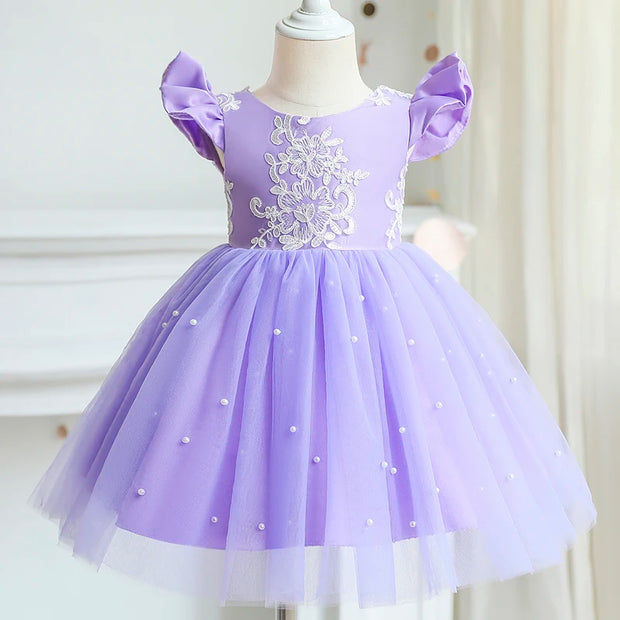 Lavender dress with floral embroidery on a mannequin against a white background