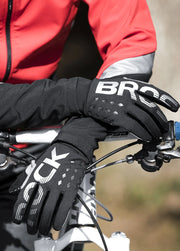 Person wearing black gloves on a bicycle.