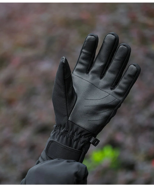 Black glove held against a blurred natural background