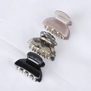 Set of three decorative hair clips on a white background