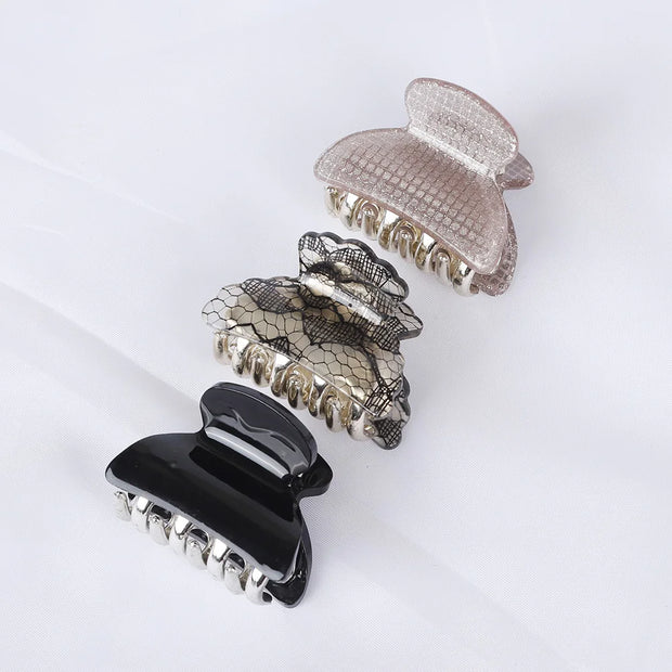 Set of three decorative hair clips on a white background