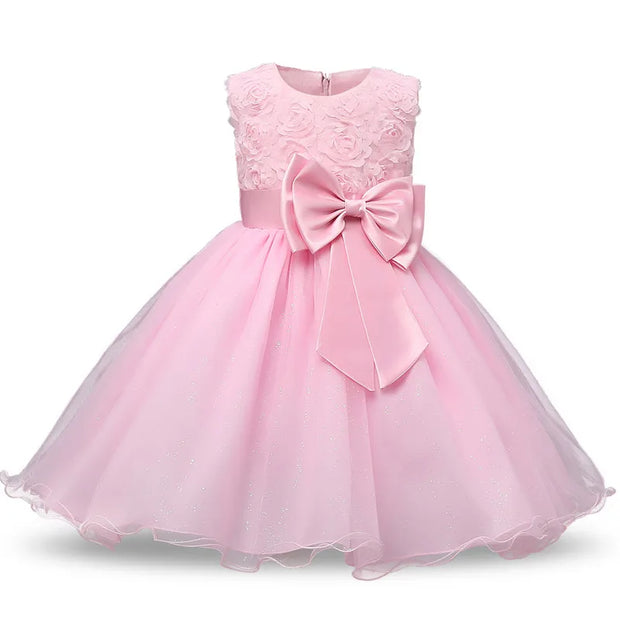 Pink dress with a large bow on a white background