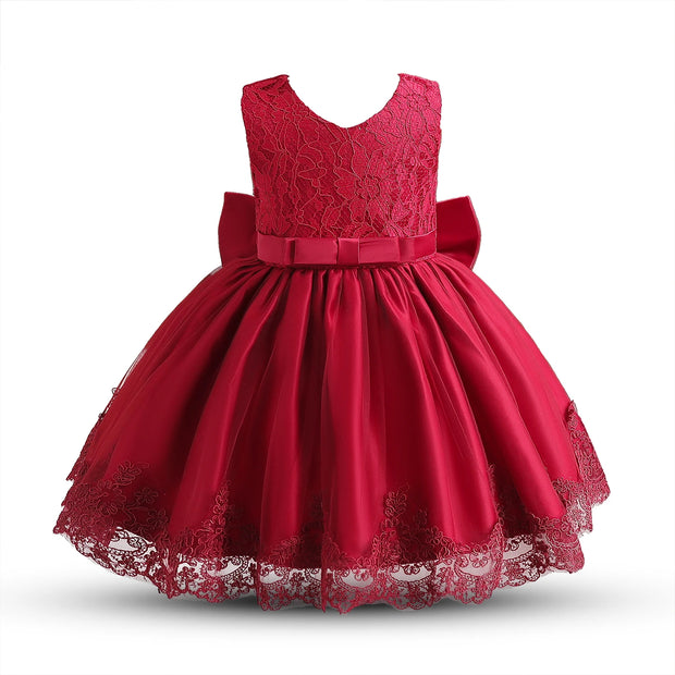 Red lace dress with a large bow on a white background