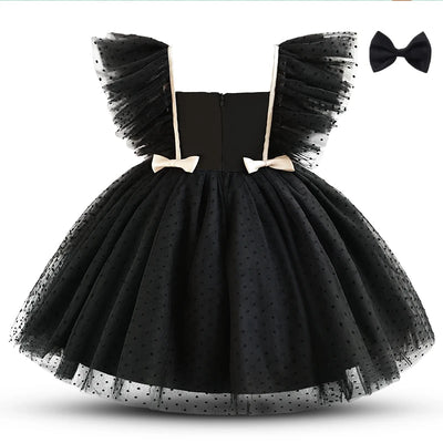Black tulle dress with bow details on a white background