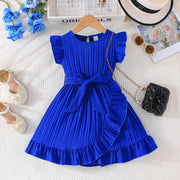 Blue pleated dress on a hanger with accessories on a white surface