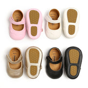 Set of children's shoes in various colors with brown soles on a white background