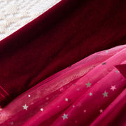 Close-up of red fabric with star patterns on a textured surface