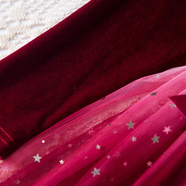 Close-up of red fabric with star patterns on a textured surface