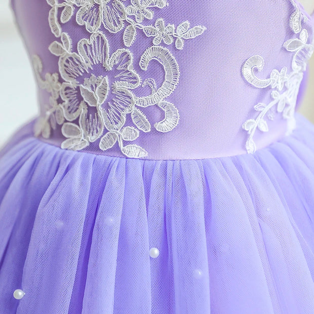 Close-up of a purple dress with white lace details on a white background