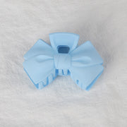 Light blue bow-shaped object on a gray background