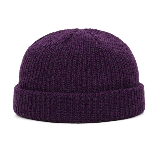 Purple knit beanie on a white background