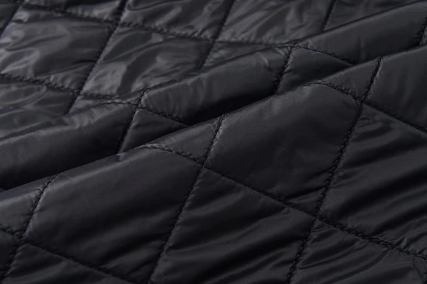 Close-up of black quilted fabric texture