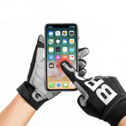 Person using a smartphone with touchscreen gloves on a white background