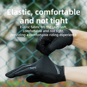 Black gloves being worn with text about elastic comfort, against a blurred green fence background.