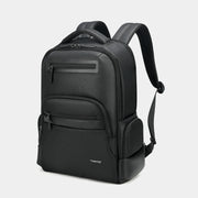 Black backpack with multiple pockets on a light gray background