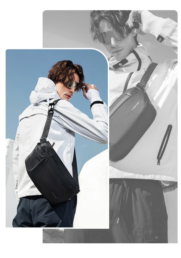 Person wearing a black crossbody bag with a blue sky background