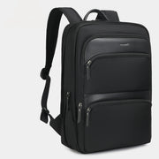 Black backpack with multiple zippers on a light gray background