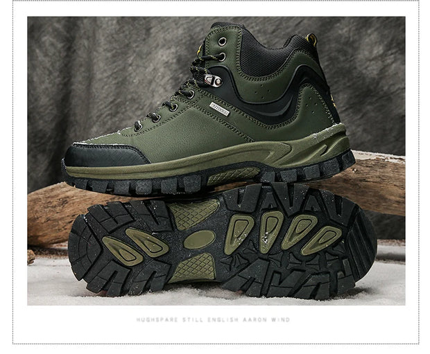 Green hiking boots with black soles on a wooden log and snowy ground background