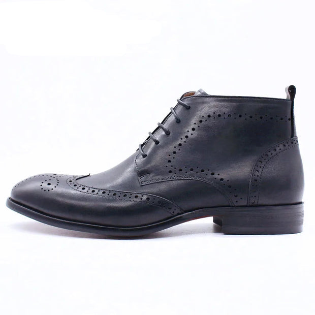 Black leather brogue shoe on a white background