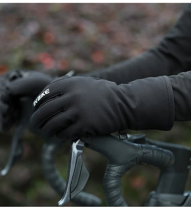 Close-up of a person wearing black gloves on a blurred background.
