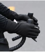 Person wearing black gloves on a blurred background